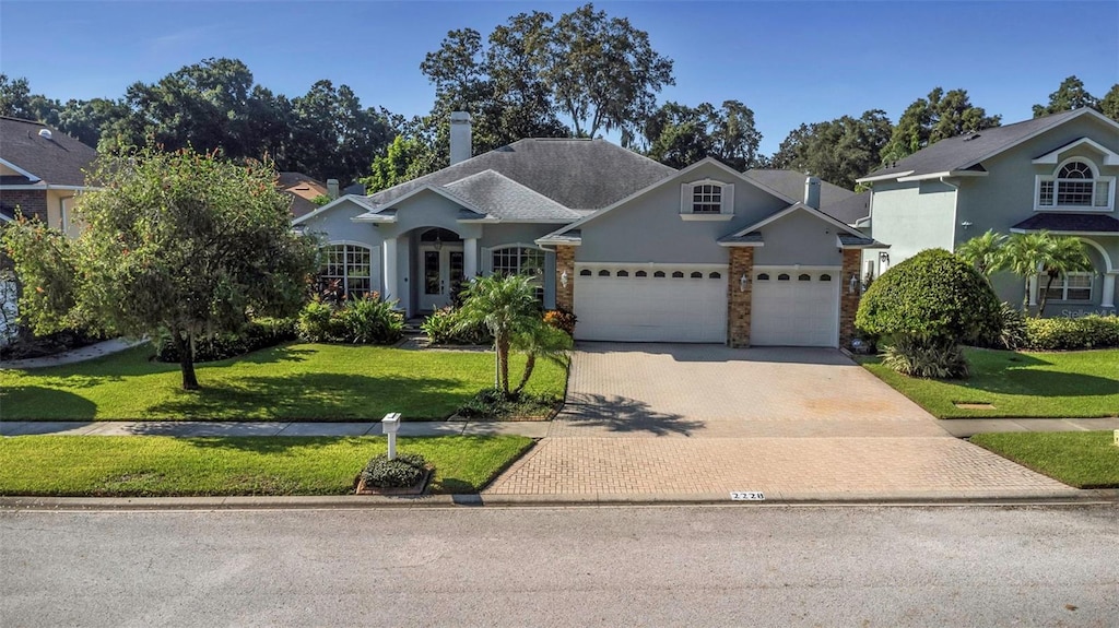 view of front of property with a front yard and a garage