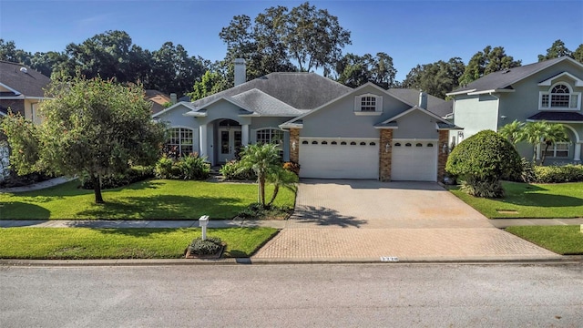 2228 Valrico Forest Dr, Valrico, FL 33594 - view of front of property with a front yard and a garage