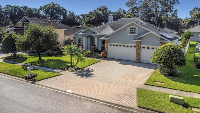 view of front facade featuring a front yard and a garage