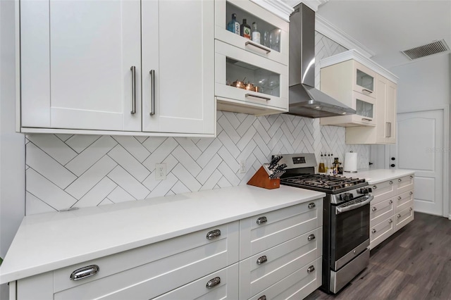 2228 Valrico Forest Dr, Valrico, FL 33594 - kitchen with gas stove, white cabinetry, dark wood-type flooring, and wall chimney range hood