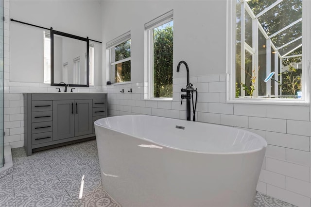 2228 Valrico Forest Dr, Valrico, FL 33594 - bathroom featuring tile walls, vanity, and a bathing tub