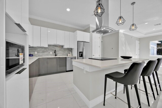 kitchen featuring appliances with stainless steel finishes, a kitchen island, and white cabinetry