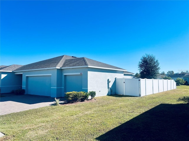 view of home's exterior with a yard and a garage