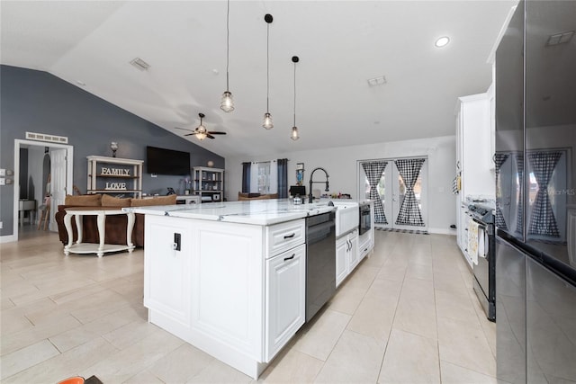 kitchen featuring ceiling fan, pendant lighting, white cabinets, a kitchen island with sink, and stainless steel appliances