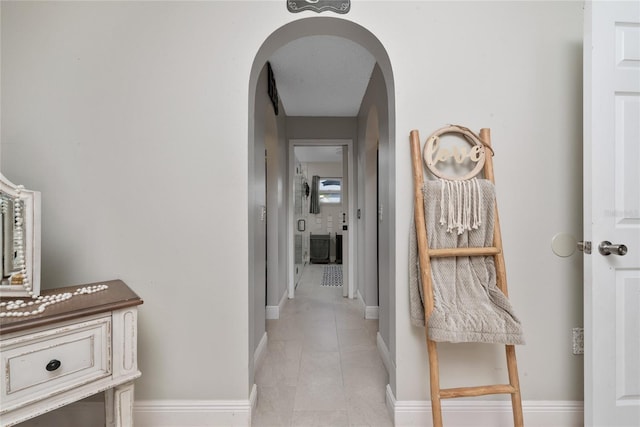 hallway featuring light tile patterned floors