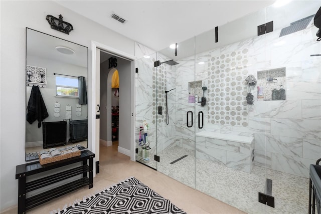 bathroom featuring an enclosed shower and tile patterned floors