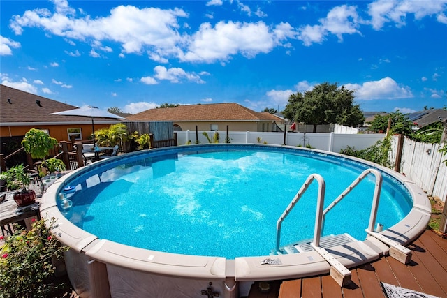 view of swimming pool with a wooden deck