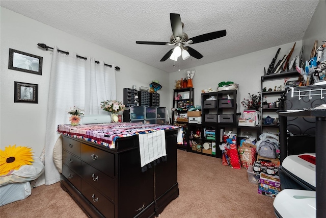 bedroom featuring ceiling fan, a textured ceiling, and light carpet