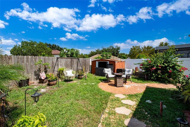 view of yard with a storage shed and a patio area