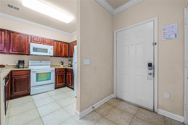 kitchen featuring white appliances, ornamental molding, light stone countertops, and light tile patterned floors