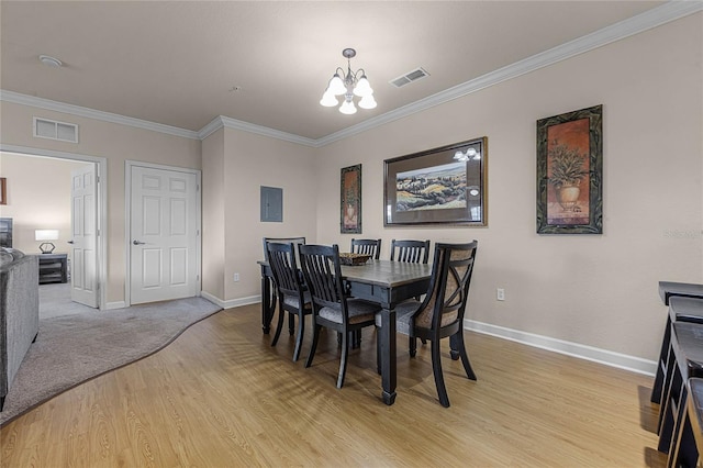 1301 Tuscan Ter Unit 9403, Davenport, FL 33896 - dining space with a chandelier, light wood-type flooring, crown molding, baseboards, and electric panel