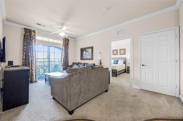 carpeted living room with ornamental molding and ceiling fan