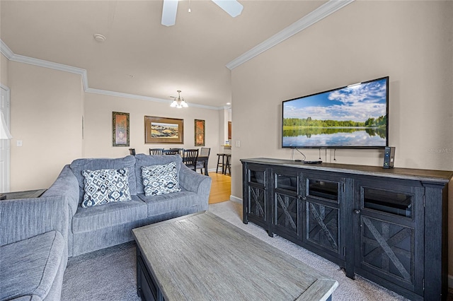 carpeted living room featuring ceiling fan with notable chandelier and ornamental molding