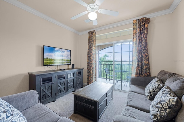 carpeted living room with ornamental molding and ceiling fan