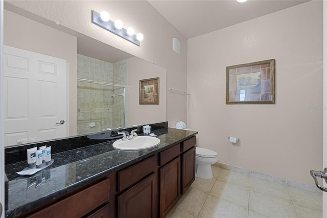 bathroom with vanity, tile patterned flooring, toilet, and a shower with door