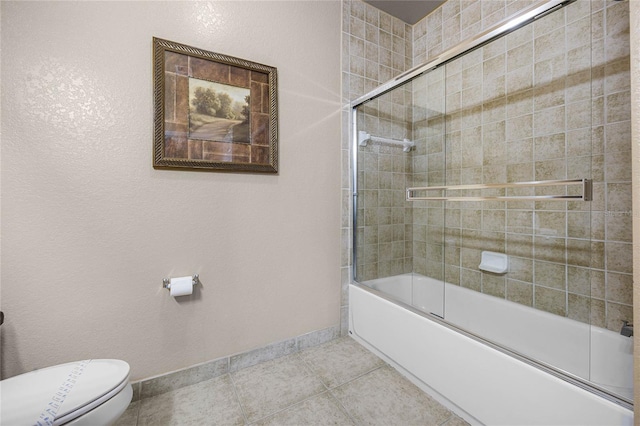 1301 Tuscan Ter Unit 9403, Davenport, FL 33896 - bathroom with baseboards, combined bath / shower with glass door, toilet, and tile patterned floors
