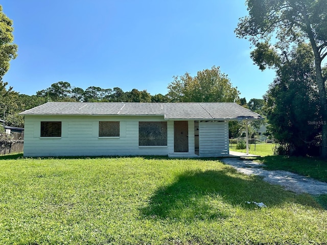 view of front of house with a front yard, fence, and driveway