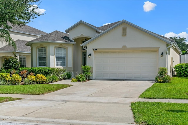 view of front of home with a garage and a front yard