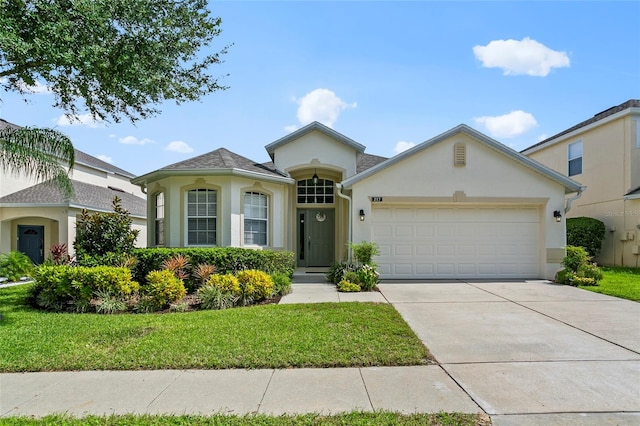 view of front facade featuring a front yard and a garage