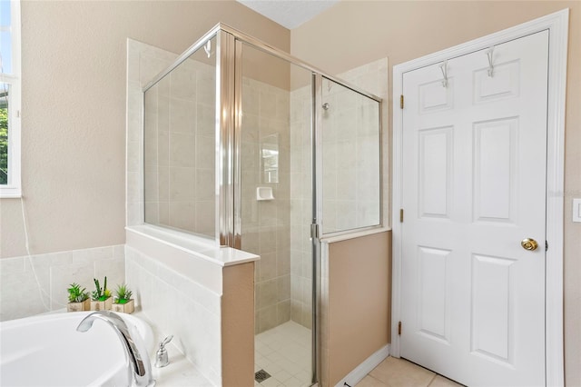 bathroom featuring independent shower and bath and tile patterned floors