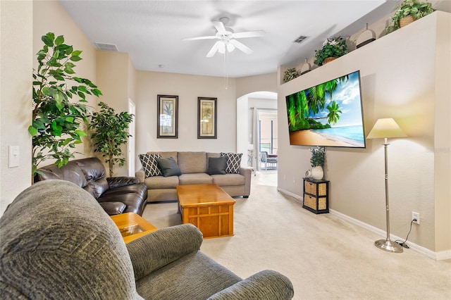 carpeted living room with ceiling fan