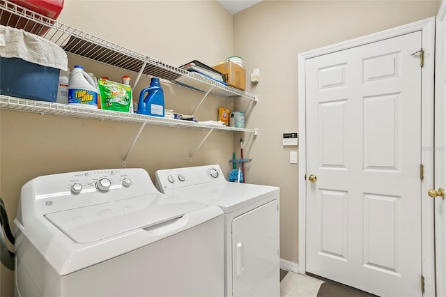 laundry room featuring light tile patterned floors and independent washer and dryer