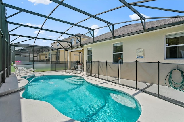 view of swimming pool with glass enclosure, a patio, and pool water feature