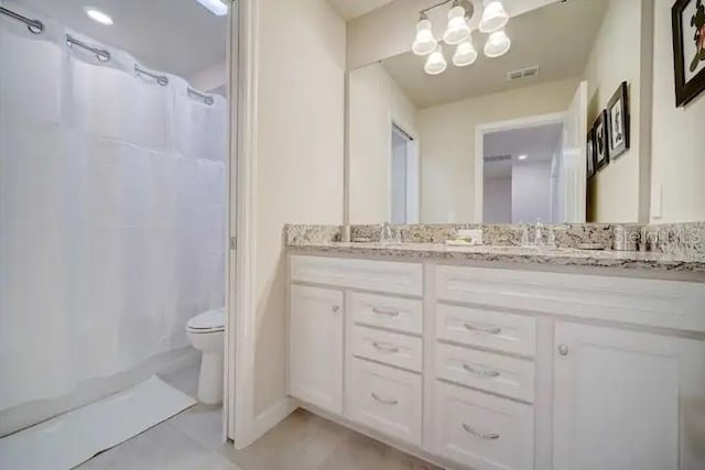 bathroom featuring tile patterned flooring, a notable chandelier, walk in shower, vanity, and toilet