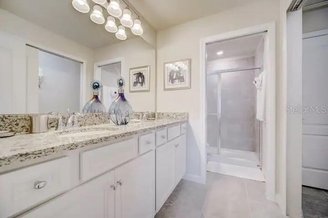 bathroom featuring vanity, tile patterned flooring, and a shower with shower door