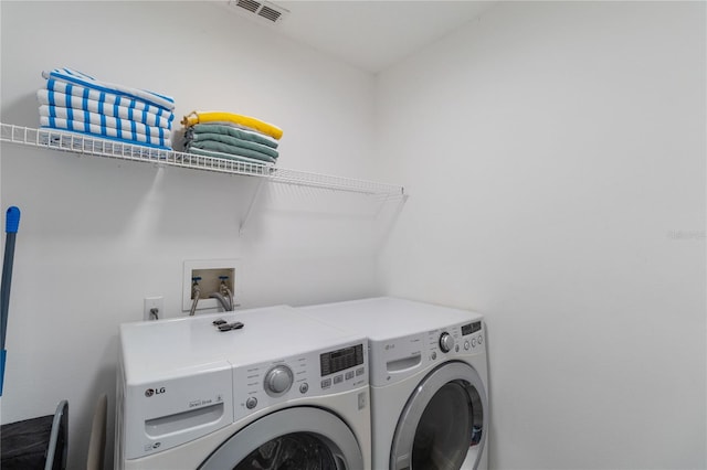 clothes washing area featuring washing machine and dryer