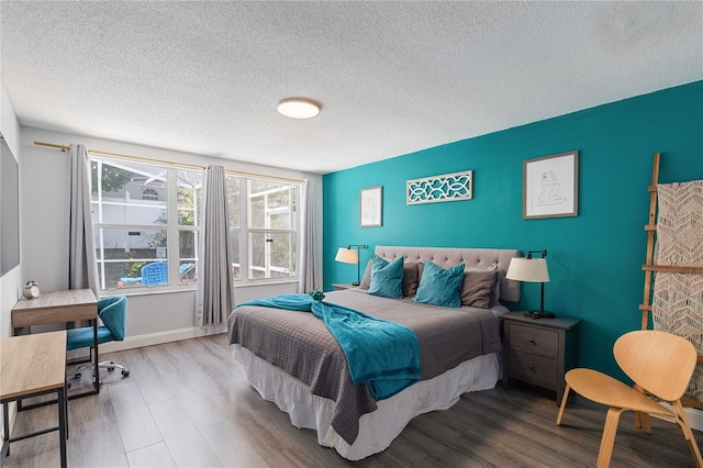 bedroom featuring hardwood / wood-style flooring and a textured ceiling