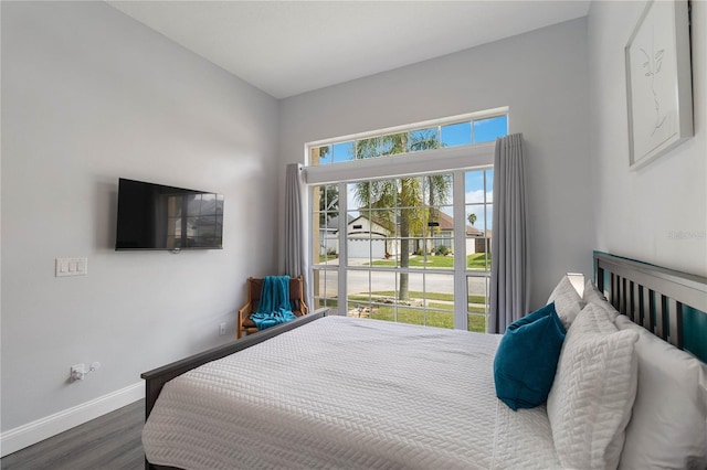 bedroom with dark hardwood / wood-style flooring