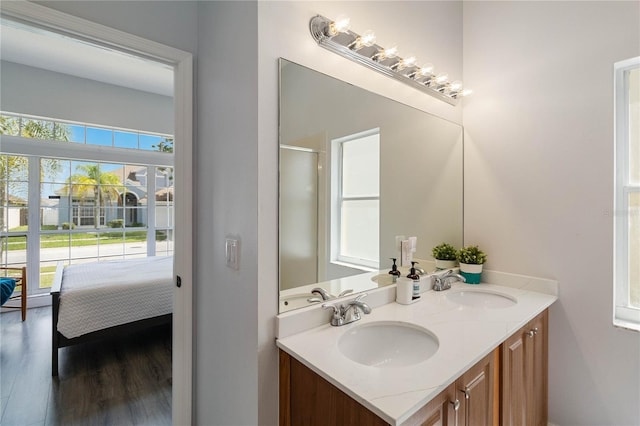 bathroom featuring an enclosed shower, vanity, and hardwood / wood-style flooring