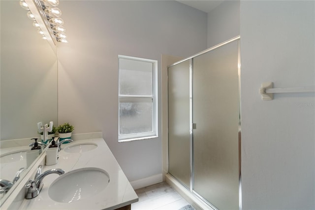 bathroom with vanity and a shower with door