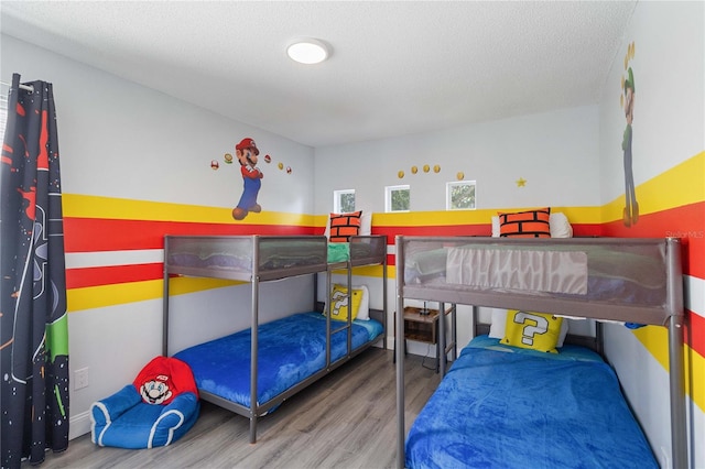 bedroom with a textured ceiling and hardwood / wood-style flooring