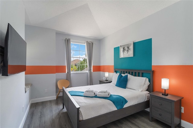 bedroom featuring vaulted ceiling and dark hardwood / wood-style floors