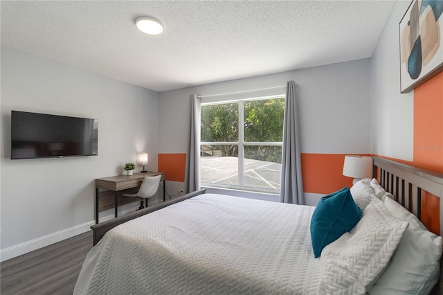 bedroom featuring a textured ceiling and hardwood / wood-style floors