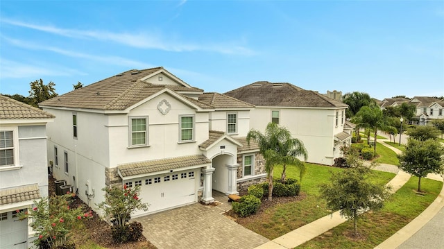 view of front of house with a front yard and a garage