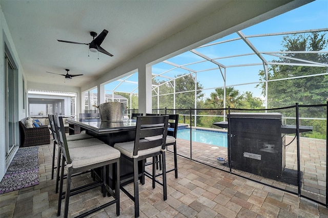 sunroom featuring a swimming pool and ceiling fan