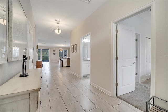 hall with light tile patterned floors