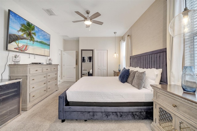 carpeted bedroom with ceiling fan and a closet