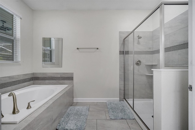 bathroom with tile patterned floors and independent shower and bath