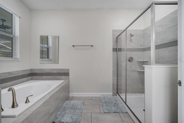 bathroom featuring plus walk in shower and tile patterned floors