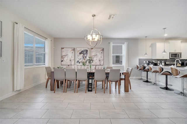 dining area featuring light tile patterned flooring and an inviting chandelier