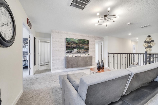 living room featuring a chandelier, a textured ceiling, and light carpet