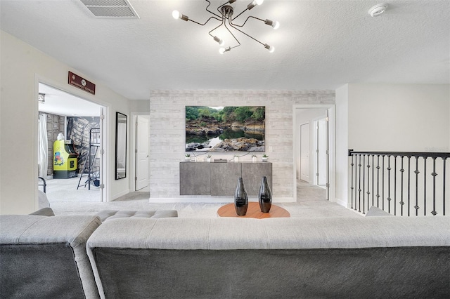 carpeted living room with a chandelier and a textured ceiling