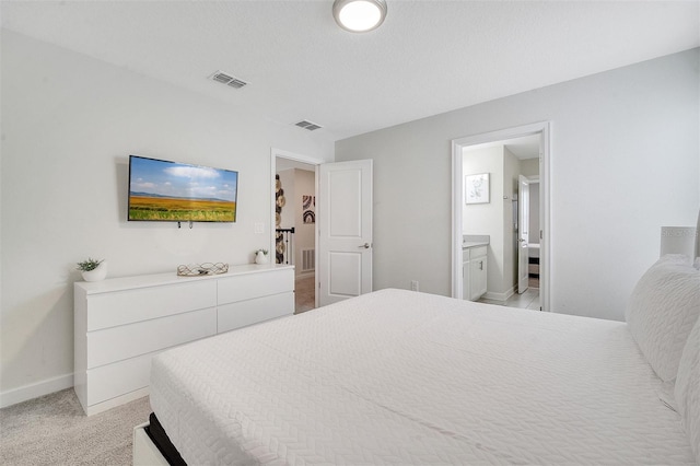 carpeted bedroom featuring ensuite bathroom