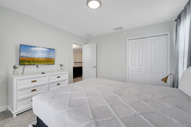 bedroom with a closet and light colored carpet