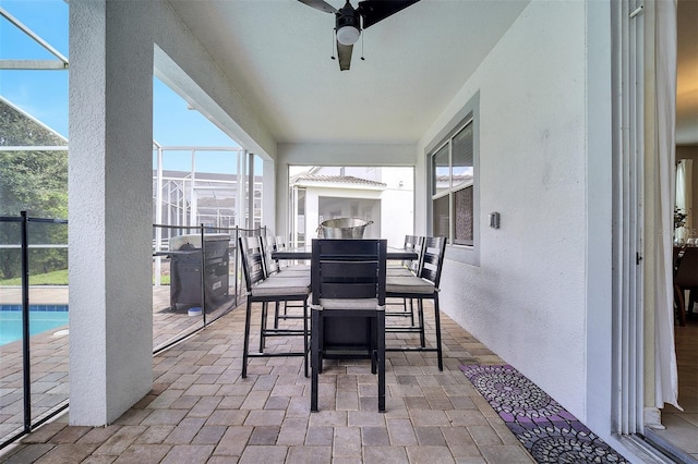 view of patio / terrace with glass enclosure and ceiling fan