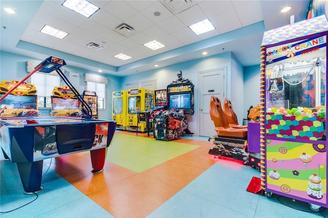 game room featuring a drop ceiling and a tray ceiling